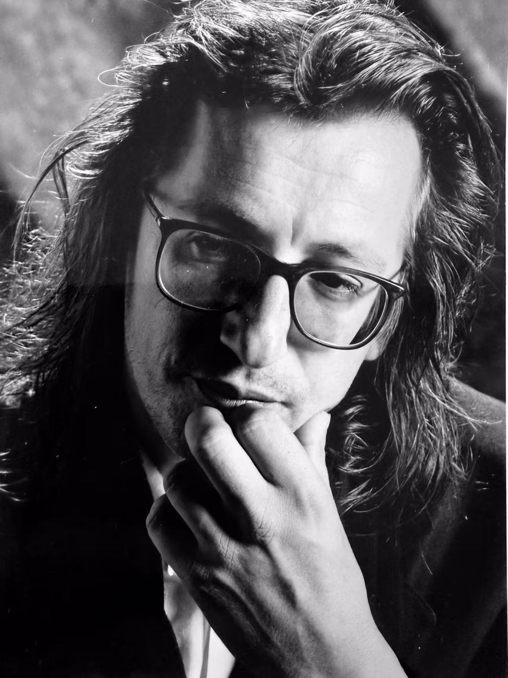 Zwart-wit close-up borstbeeld met bril en hand voor mond in diepe overpeinzing over johan doesburg